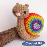 Small rainbow crocheted snail on a white background