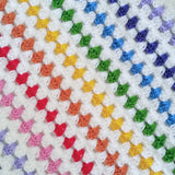 CLose up of rainbow crochet blanket