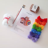 Contents of DIY crochet snail kit laid out on a white background